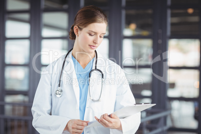 Female doctor holding clipboard