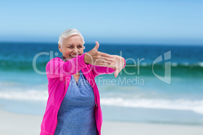 Thoughtful mature woman outstretching her arms