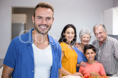Handsome young man standing in kitchen