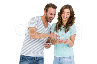 Happy young couple looking at mobile phone