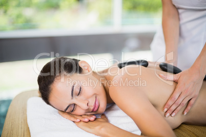 Beautiful woman enjoying stone massage