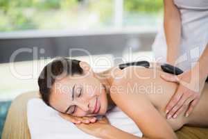 Beautiful woman enjoying stone massage