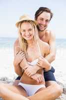 Portrait of young couple embracing on the beach