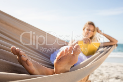 Woman reading book in hammock