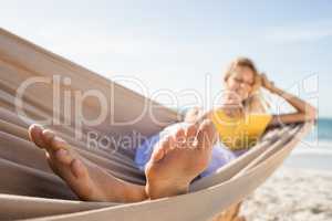 Woman reading book in hammock