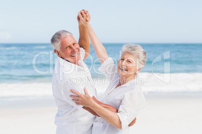 Senior couple dancing on the beach