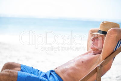 Mature man relaxing on a deck chair