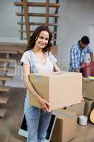 Portrait of smiling woman holding box