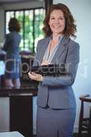 Smiling businesswoman taking notes