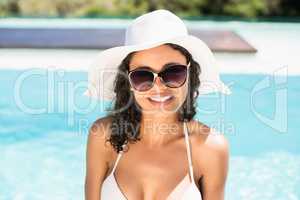 Portrait of beautiful woman in bikini wearing sunglasses