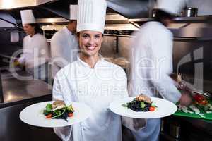 Happy chef presenting her food plates