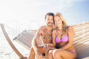 Smiling couple sitting in hammock