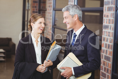 Happy business people discussing at office