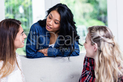 Female friends discussing in living room