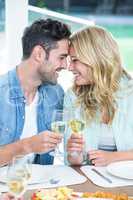 Romantic couple holding white wine glasses