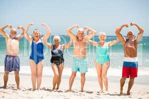 Seniors posing with muscles at the beach