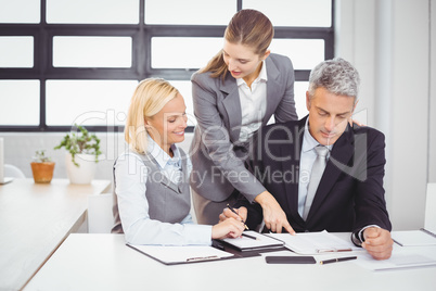 Business people explaining client with documents