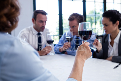 Group of businesspeople drinking wine glass during business lunc