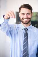 Businessman smiling while showing house keys