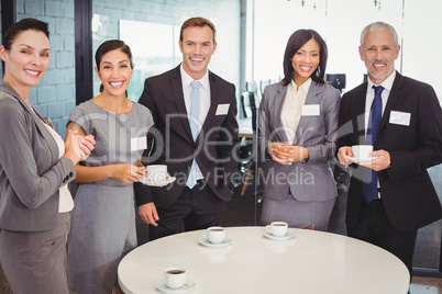 Portrait of businesspeople having tea during breaktime
