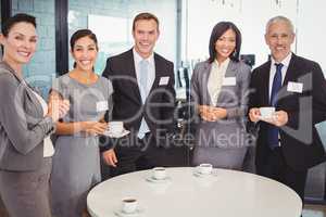 Portrait of businesspeople having tea during breaktime