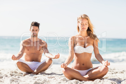 Happy couple doing yoga