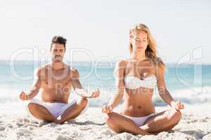 Happy couple doing yoga