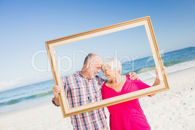 Senior couple holding frame