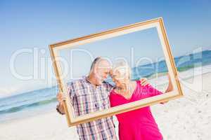 Senior couple holding frame
