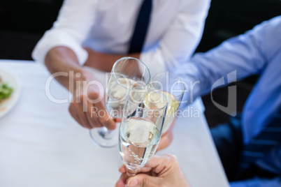 Hands toasting champagne flutes