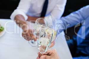 Hands toasting champagne flutes