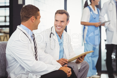 Two doctors with clipboard and discussing