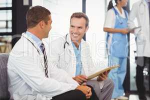 Two doctors with clipboard and discussing