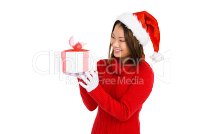 Woman in christmas attire holding gift