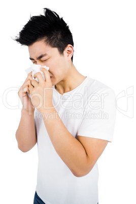 Young man wiping his nose