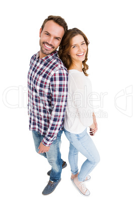 Happy young couple standing back to back