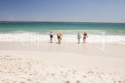 Senior friends holding surfboard