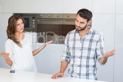 Woman explaining man by table