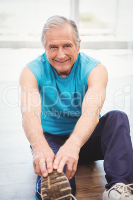 Senior man exercising at health club