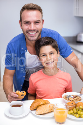 Father and son having breakfast