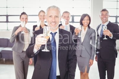 Portrait of businessman holding champagne flute