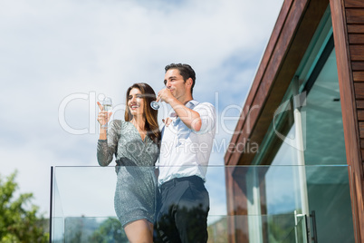 Young couple drinking champagne at balcony