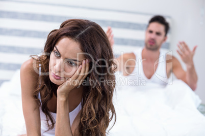 Wife sitting while husband shouting at her