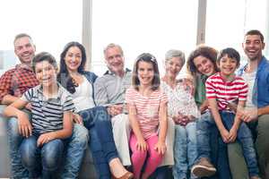 Happy family sitting on sofa