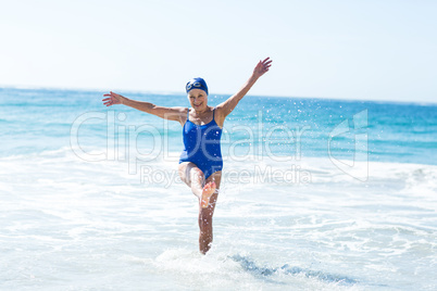 Pretty mature woman playing on the beach