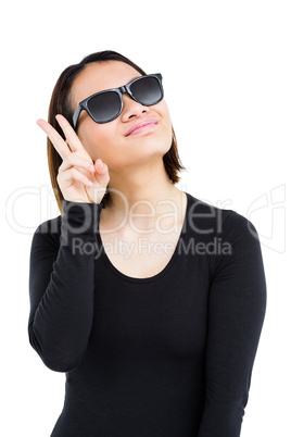 Woman in sunglasses making a v sign