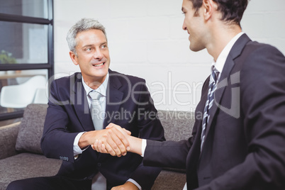 Smiling businessmen handshaking