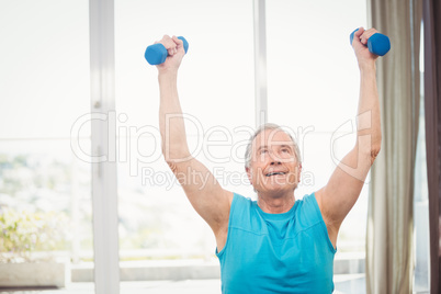 Senior man holding dumbbells