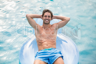 Handsome man relaxing on inflatable ring