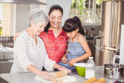 Grandmother with family making bread